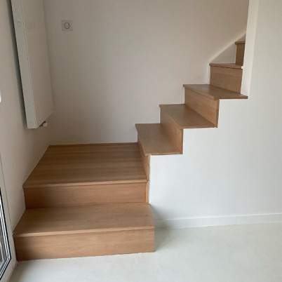 Renovation of concrete staircase with wooden steps and risers