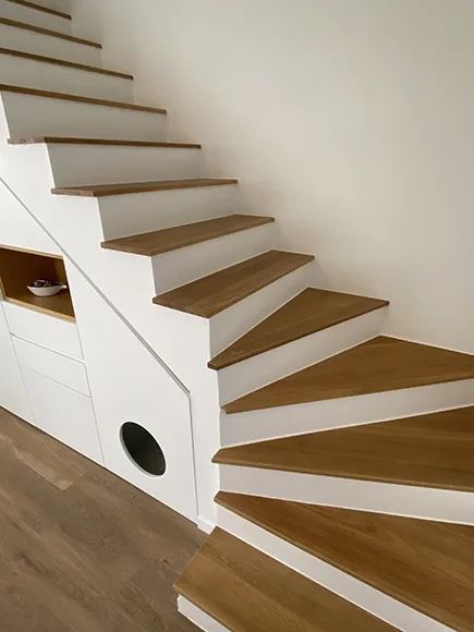 Corner staircase with wooden treads and white risers