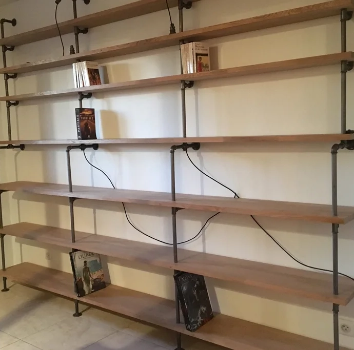 Custom bookcase with solid oak shelves and cast iron pipes