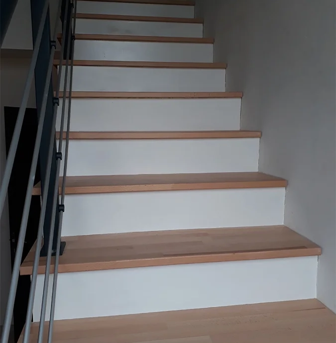 Solid beech steps on concrete staircase