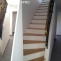 Custom-made concrete staircase cladding with oak wood steps