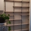 Make a custom shelf with wooden planks and plumbing pipes